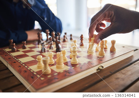 Hands, fun and people with a chess game, strategy and playing together at a competition. Table, professional and friends with a board for gaming, learning and expert with a skill or hobby in a room Hands, fun and people with a chess game, strategy and playing together at a competition. Table, professional and friends with a board for gaming, learning and expert with a skill or hobby in a room 136314041