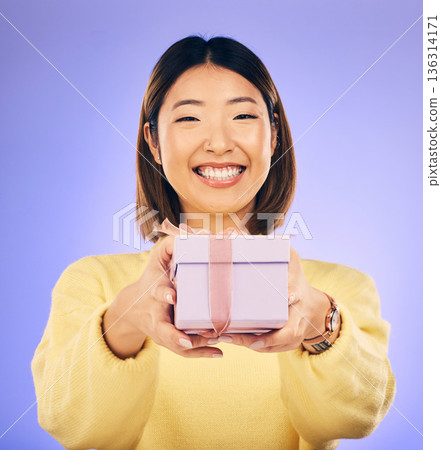 Portrait, smile and Asian woman with a gift, box and celebration against a studio background. Face, happy female person or model with happiness, present and giveaway with a ribbon, surprise and prize Portrait, smile and Asian woman with a gift, box and celebration against a studio background. Face, happy female person or model with happiness, present and giveaway with a ribbon, surprise and prize 136314171
