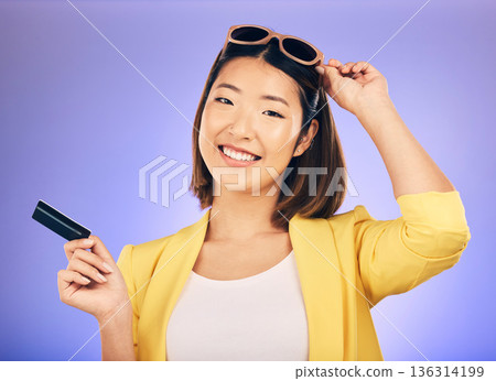 Credit card, shopping portrait and woman in sunglasses, retail banking and finance, e commerce or payment. Happy customer, fashion model or asian person for debit pay on studio purple background Credit card, shopping portrait and woman in sunglasses, retail banking and finance, e commerce or payment. Happy customer, fashion model or asian person for debit pay on studio purple background 136314199