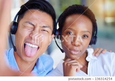 Call center, selfie and business people tongue out in office consulting for crm, contact us or customer service. Portrait, telemarketing and crazy consultant friends with diversity in profile picture Call center, selfie and business people tongue out in office consulting for crm, contact us or customer service. Portrait, telemarketing and crazy consultant friends with diversity in profile picture 136314254