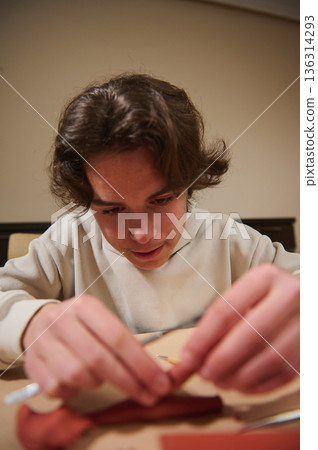 Boy Focused On Molding Clay At Home, Creative Hobby Activity For Crafting Boy Focused On Molding Clay At Home, Creative Hobby Activity For Crafting 136314293