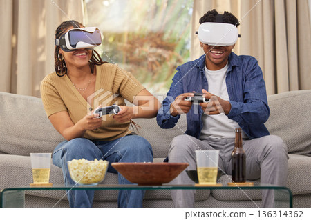 Couple in digital world, virtual reality and video game, esports and people at home on futuristic gaming date. Time together, metaverse with man and woman in lounge, 3D games and tech with challenge Couple in digital world, virtual reality and video game, esports and people at home on futuristic gaming date. Time together, metaverse with man and woman in lounge, 3D games and tech with challenge 136314362