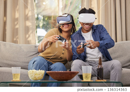 Couple, virtual reality and video games, esport and metaverse, people at home and futuristic gaming date. Time together, fun and digital world with man and woman in living room with 3D games and tech Couple, virtual reality and video games, esport and metaverse, people at home and futuristic gaming date. Time together, fun and digital world with man and woman in living room with 3D games and tech 136314363