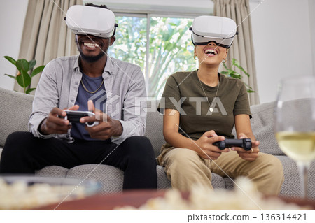 Virtual reality, happy couple and gaming on sofa in home living room, bonding together or having fun. Vr, couch and African man and woman play 3d game, metaverse or esports with futuristic technology Virtual reality, happy couple and gaming on sofa in home living room, bonding together or having fun. Vr, couch and African man and woman play 3d game, metaverse or esports with futuristic technology 136314421