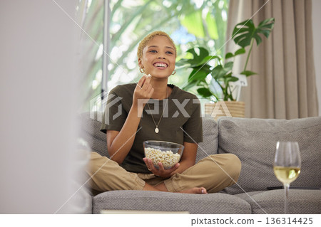 Happy woman, popcorn and watching tv with comedy and entertainment, streaming service and relax at home. Female person on sofa, subscription and internet, watch funny film or series with cinema snack Happy woman, popcorn and watching tv with comedy and entertainment, streaming service and relax at home. Female person on sofa, subscription and internet, watch funny film or series with cinema snack 136314425