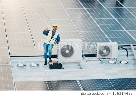 Engineer woman, solar panel and thumbs up with smile for clean power, sustainability or success on roof. Technician, photovoltaic technology and happy with goal, winner and sign with electricity grid 136314482