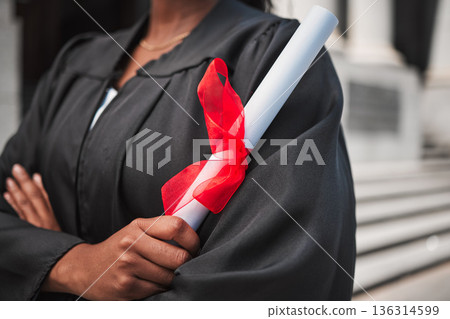 University, graduation and certificate with a student arms crossed on campus, confident in her achievement. Diploma, education and college with an african graduate standing outdoor at a ceremony 136314599