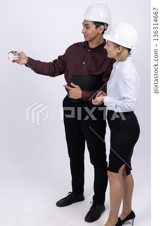 Engineer pointing at something to his colleague in studio 136314667