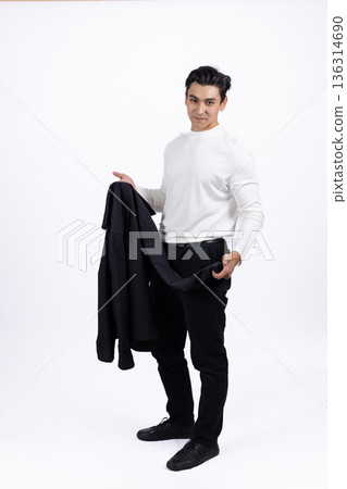 Young man in white sweatshirt holding blazer over shoulder Young man in white sweatshirt holding blazer over shoulder 136314690
