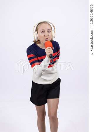Young woman in striped sweater looking surprised Young woman in striped sweater looking surprised 136314696