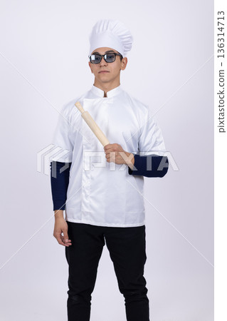 Professional male chef in white uniform and glasses posing 136314713