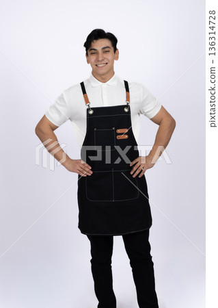 Professional waiter in black apron with hands behind back Professional waiter in black apron with hands behind back 136314728
