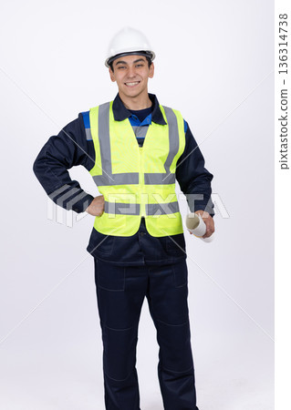 Confident engineer in reflective vest with hands on hips Confident engineer in reflective vest with hands on hips 136314738