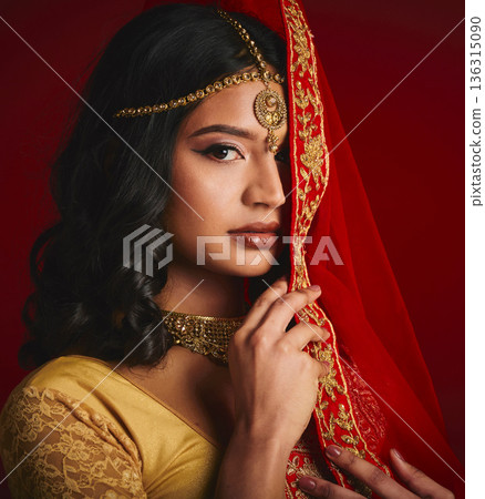 Fashion, beauty and portrait of Indian woman with veil in traditional clothes, jewellery and sari. Religion, culture and eyes of female person on red background with accessory, cosmetics and makeup Fashion, beauty and portrait of Indian woman with veil in traditional clothes, jewellery and sari. Religion, culture and eyes of female person on red background with accessory, cosmetics and makeup 136315090
