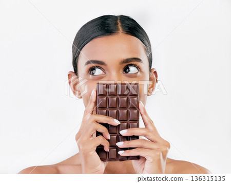 Woman, thinking and chocolate in sweet diet or unhealthy eating against a white studio background. Female person or model with cocoa slab, block or bar in delicious treat, snack or diabetes on mockup Woman, thinking and chocolate in sweet diet or unhealthy eating against a white studio background. Female person or model with cocoa slab, block or bar in delicious treat, snack or diabetes on mockup 136315135