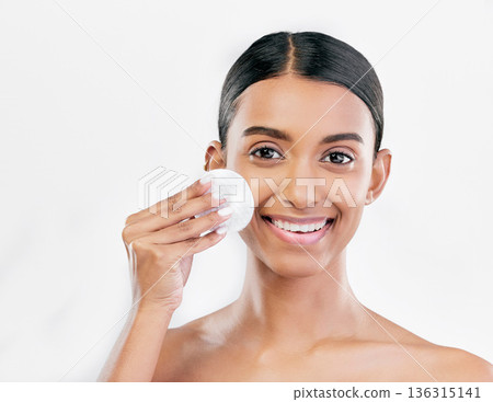 Woman, face and cotton pad, beauty and makeup remover with skincare isolated on white background. Smile, portrait and dermatology, skin health and glow with young female model and clean facial Woman, face and cotton pad, beauty and makeup remover with skincare isolated on white background. Smile, portrait and dermatology, skin health and glow with young female model and clean facial 136315141