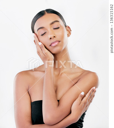 Hand on face, beauty and a woman with natural skin care isolated on a white background. Dermatology, makeup glow and cosmetics with Indian female model for facial shine and self love in studio 136315162