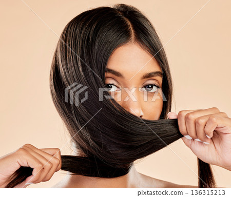 Hair care, strong and portrait of a woman on a studio background for keratin, shampoo or hairdresser. Salon, health and an Indian girl or model showing hairstyle shine isolated on a backdrop Hair care, strong and portrait of a woman on a studio background for keratin, shampoo or hairdresser. Salon, health and an Indian girl or model showing hairstyle shine isolated on a backdrop 136315213