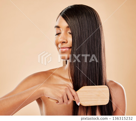 Face, hair beauty and brush with a woman in studio on a cream background for natural or luxury style. Haircare, growth and shampoo treatment with a young indian female model eyes closed at a salon Face, hair beauty and brush with a woman in studio on a cream background for natural or luxury style. Haircare, growth and shampoo treatment with a young indian female model eyes closed at a salon 136315232