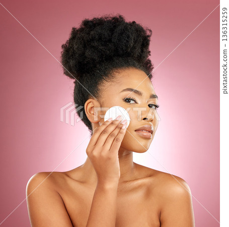 Black woman, cotton pad and portrait with makeup, dermatology and skincare on a studio background. Female person, shine and model with cosmetics, aesthetic and cleaning with beauty, glow and patches 136315259