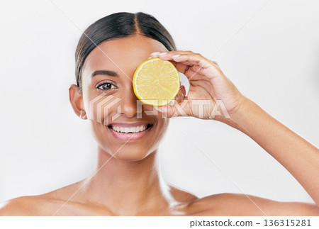 Happy, lemon and portrait of a woman for nutrition, beauty glow or vitamin c for skincare. Smile, wellness and an Indian model or girl with fruit for diet isolated on a white background in a studio Happy, lemon and portrait of a woman for nutrition, beauty glow or vitamin c for skincare. Smile, wellness and an Indian model or girl with fruit for diet isolated on a white background in a studio 136315281
