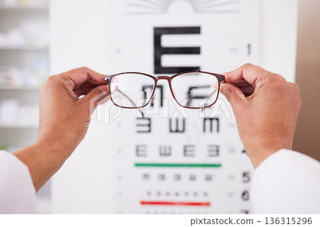 Glasses in hands, optometry and vision, eye care and health with eyesight test and chart, prescription lens and frame. Ophthalmology, focus and healthcare, person in optometrist clinic and eyewear Glasses in hands, optometry and vision, eye care and health with eyesight test and chart, prescription lens and frame. Ophthalmology, focus and healthcare, person in optometrist clinic and eyewear 136315296