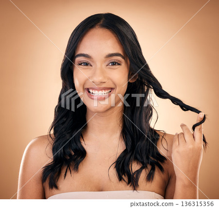 Portrait, hair and beauty with a model woman in studio on a brown background for shampoo treatment. Smile, salon and haircare with a happy young person looking confident about natural cosmetics 136315356