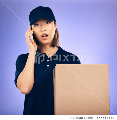 Asian woman, phone call and box for delivery, courier service or logistics against a purple studio background. Portrait of female person talking on mobile smartphone with package, parcel or order 136315359