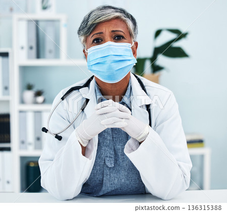 Healthcare, face mask and portrait of a female doctor in her office in the hospital for disease diagnosis. Gloves, concern and professional senior woman medical worker with virus prevention in clinic 136315388