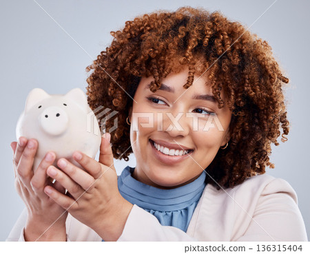 Woman with smile, piggy bank and savings in studio, finance and budget in hands with investment loan. Happiness, growth and profit inflation, salary management girl with money box on white background 136315404