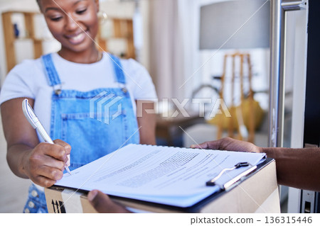 Ecommerce, black woman sign paperwork and package delivery at front door. Online shopping or logistics, supply chain or distribution and happy African female person receive parcel box with documents 136315446