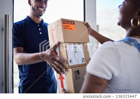 Ecommerce, delivery man with package boxes and woman at her front door for logistics. Distribution or online shopping, courier supply chain or shipping and happy man with cardboard parcel packaging Ecommerce, delivery man with package boxes and woman at her front door for logistics. Distribution or online shopping, courier supply chain or shipping and happy man with cardboard parcel packaging 136315447