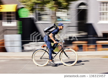 Delivery man, bicycle and motion blur in city for fast logistics, quick distribution service and order. Courier, guy or travel with speed on bike, cycle and transportation for package in urban street 136315457