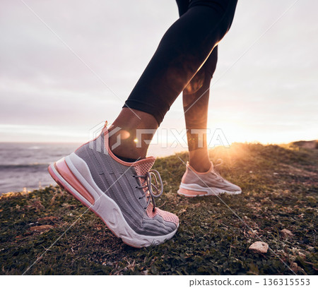 Shoes, closeup and beach ground for fitness, workout and training to start a run. Outdoor, sunset and feet with sports by the sea and ocean for exercise and running in nature with sunshine by sky 136315553