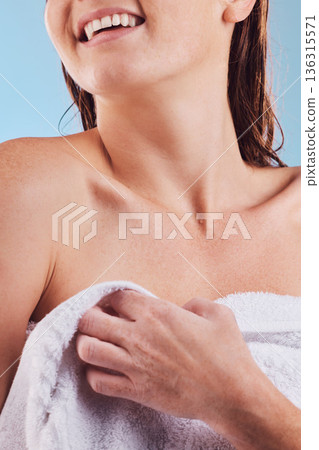 Happy woman, hands and towel in shower for hygiene, clean body or washing against a blue studio background, Closeup of female person smile for bathroom routine, self care or grooming in cleanliness 136315571