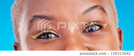 Makeup portrait, eyeliner and eyes of black woman with studio beauty, wellness and facial cosmetics for skincare shine. Mascara, cosmetology design and closeup African person on blue background. Makeup portrait, eyeliner and eyes of black woman with studio beauty, wellness and facial cosmetics for skincare shine. Mascara, cosmetology design and closeup African person on blue background. 136315642