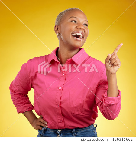 Happy, black woman and hand pointing in studio for news, deal or coming soon announcement on yellow background. Finger, smile and excited African female show list, promo or sign up contact info 136315662