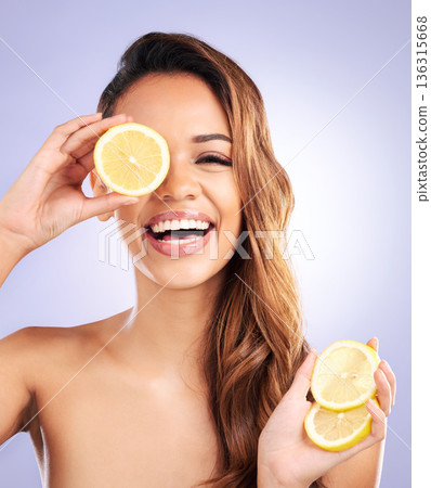 Vitamin c, lemon and eye of woman with beauty, natural or organic wellness isolated in a brown studio background. Excited, happy and healthy young female person with citrus for skincare or detox Vitamin c, lemon and eye of woman with beauty, natural or organic wellness isolated in a brown studio background. Excited, happy and healthy young female person with citrus for skincare or detox 136315668