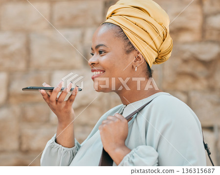 Phone, voice recognition and woman in the city walking in an urban street to her office. Technology, happy and African female designer recording a message on cellphone while commuting in town road. Phone, voice recognition and woman in the city walking in an urban street to her office. Technology, happy and African female designer recording a message on cellphone while commuting in town road. 136315687