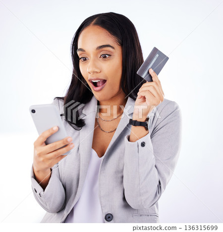 Business woman, credit card and surprise for online shopping on smartphone, studio and fintech payment. Female worker, wow and mobile banking for discount deal, sales investment and finance account 136315699