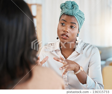 Conversation, business people and meeting or interview in office with a black woman as leader. A serious African female entrepreneur with employee talking for advice, idea or communication at work 136315733