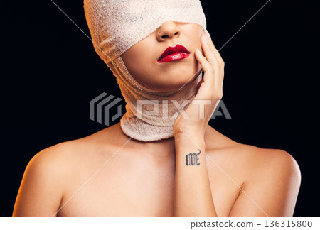 Bandage, plastic surgery and a woman with cosmetics on a dark background for a medical procedure. Beauty, healing and a girl or model after botox or facial change isolated on a studio backdrop 136315800