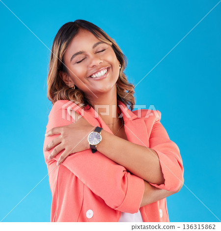 Professional, hug and business woman in studio for self love, support and care with confidence. Corporate, happy and female person embrace for positive mindset, pride and happiness on blue background Professional, hug and business woman in studio for self love, support and care with confidence. Corporate, happy and female person embrace for positive mindset, pride and happiness on blue background 136315862