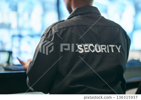 Office safety, back and man or security for a business or building for service. Law patrol, working and a worker at a professional job as a bodyguard or agent for protection at a workplace or agency Office safety, back and man or security for a business or building for service. Law patrol, working and a worker at a professional job as a bodyguard or agent for protection at a workplace or agency 136315937
