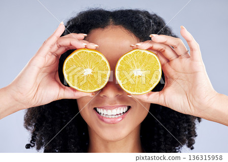 Woman, lemon eyes and skincare in studio for comic smile, health or nutrition for wellness by background. Girl, African model and fruits for diet, cleaning and cosmetic for beauty, self care or emoji Woman, lemon eyes and skincare in studio for comic smile, health or nutrition for wellness by background. Girl, African model and fruits for diet, cleaning and cosmetic for beauty, self care or emoji 136315958
