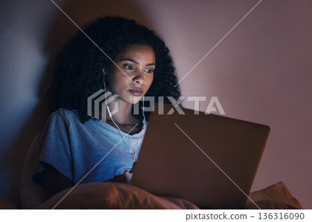 Laptop, bedroom and woman with music at night for radio, podcast sound and online social media in home. Bed, computer and person with earphones streaming movie, film and video on tech with insomnia 136316090