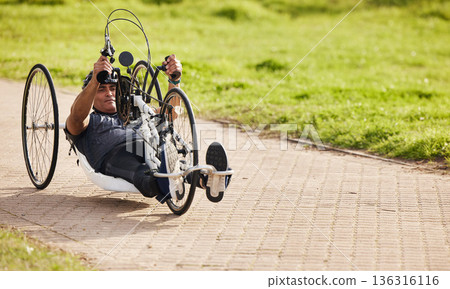 Sports, fitness and man with disability on bike, training for competition with motivation and cycling exercise. Path, cycle workout and person on recumbent bicycle for outdoor race track challenge. Sports, fitness and man with disability on bike, training for competition with motivation and cycling exercise. Path, cycle workout and person on recumbent bicycle for outdoor race track challenge. 136316116