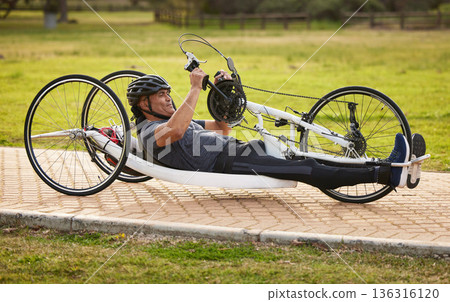 Cycling, sports and fitness with man and handcycle on road for training, bike and challenge. Exercise, workout and marathon with person with a disability riding in park for cardio and health Cycling, sports and fitness with man and handcycle on road for training, bike and challenge. Exercise, workout and marathon with person with a disability riding in park for cardio and health 136316120