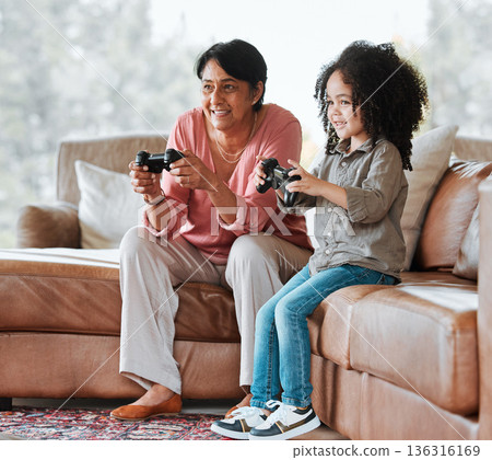 Grandma, child and video game on couch, controller and happy together with bond, contest and love in lounge. Senior woman, young kid and playing with gaming, esports and competition in family house Grandma, child and video game on couch, controller and happy together with bond, contest and love in lounge. Senior woman, young kid and playing with gaming, esports and competition in family house 136316169