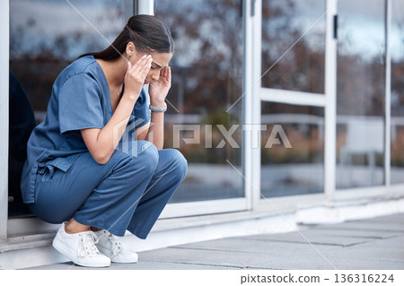 Anxiety, doctor or a woman with a headache from healthcare, surgery mistake or death at a hospital. Sad, depressed and a tired female nurse with a migraine or burnout from medical career at a clinic 136316224